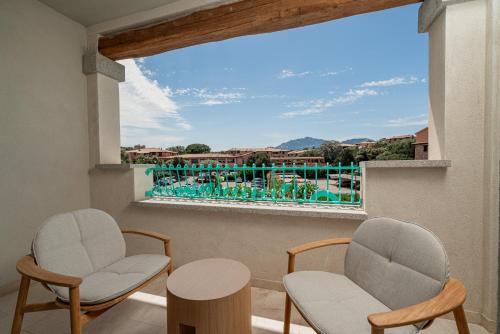 a balcony with two chairs and a table and a view at Hotel Sestante in Porto Rotondo