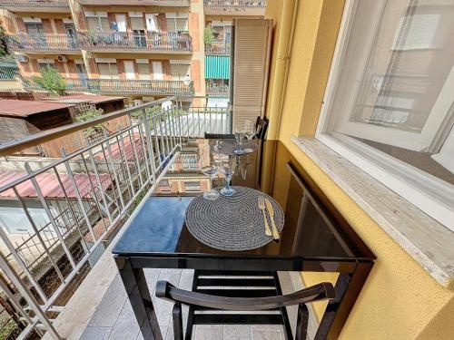 a table and chair on a balcony with a window at La Casetta di Francy in Santa Marinella