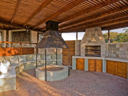 an outdoor kitchen with a pizza oven in a house at Silverstreams Lodge, Villas & Cottages, Oribi Gorge in Glendale