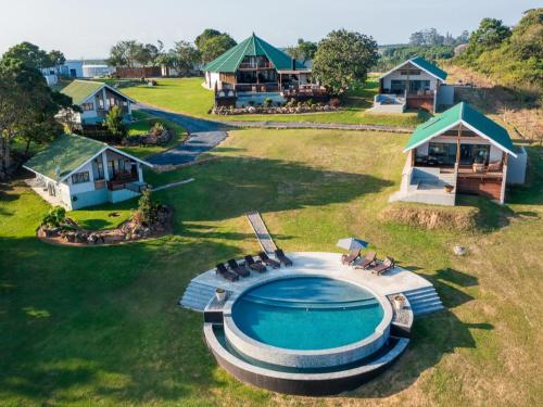 an aerial view of a house with a swimming pool at Silverstreams Lodge, Villas & Cottages, Oribi Gorge in Glendale