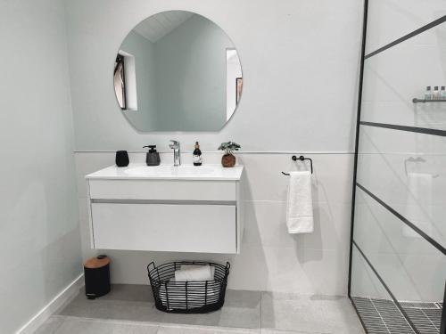 a white bathroom with a sink and a mirror at Silverstreams Lodge, Villas & Cottages, Oribi Gorge in Glendale
