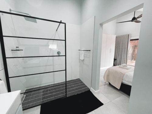 a bathroom with a shower with a glass door at Silverstreams Lodge, Villas & Cottages, Oribi Gorge in Glendale