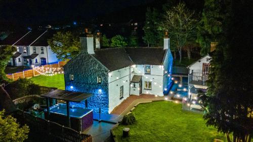 an aerial view of a large house at night at Farm House at Mochdre Cottages in Conwy