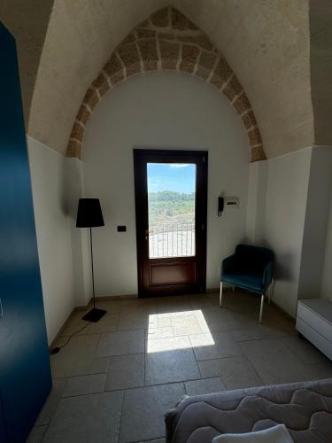 a room with a window and a couch and a chair at Borgo Angelica B&B in Leporano Marina