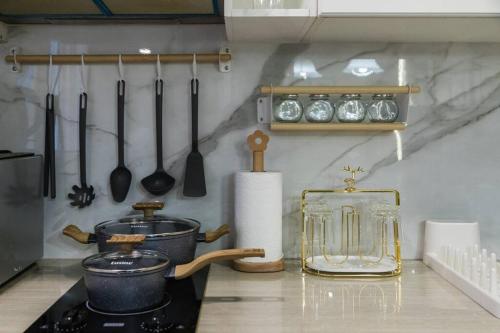a kitchen with a counter with utensils and a stove at BKK Sukumvit71 1 Bed 2 Bath 1 Living 1 Kitchen in Bangkok