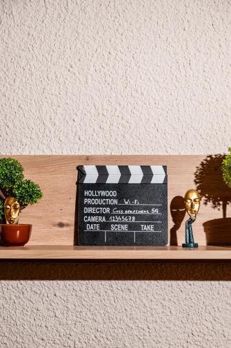 a shelf with two statues and a box on it at Cozy apartment in city center in Belgrade