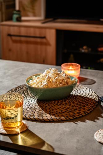 a bowl of popcorn and a drink on a table at Cozy apartment in city center in Belgrade
