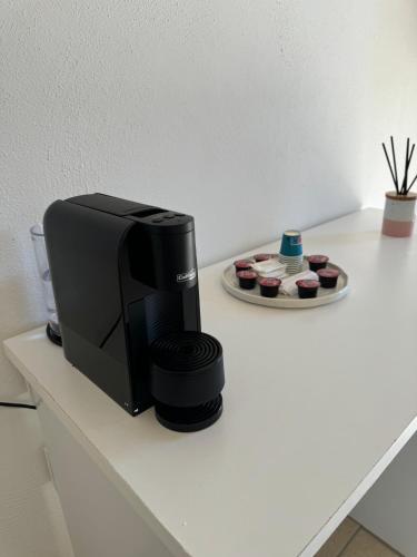 a microwave sitting on a counter next to cupcakes at Borgo Angelica B&B in Leporano Marina