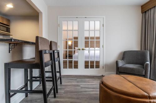 a living room with two chairs and a table at Atrium Hotel Vancouver in Vancouver