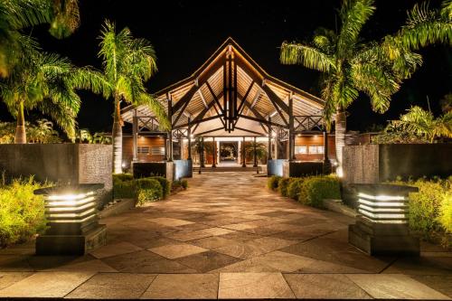 a pavilion at night with palm trees at Palm Hotel & Spa in Petite Île