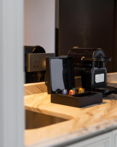 a telephone sitting on top of a counter at The Salil Hotel Riverside Bangkok in Bangkok