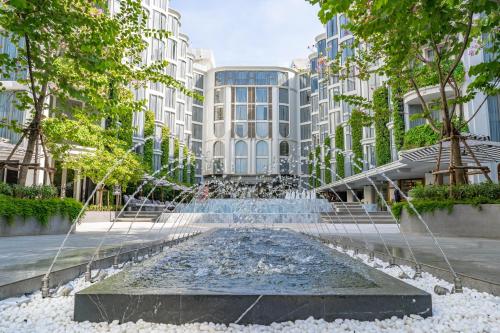a water fountain in front of a building at The Salil Hotel Riverside Bangkok in Bangkok