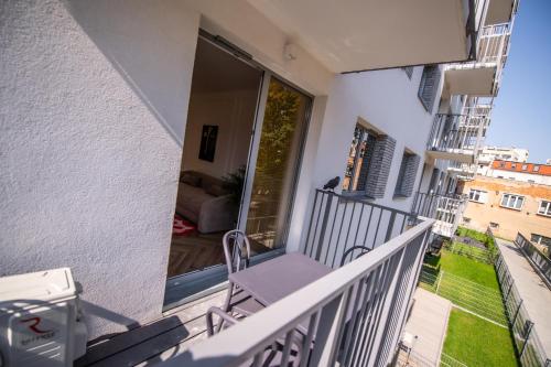 a balcony with a chair and a couch at Apartament Mikołowska z balkonem in Gliwice