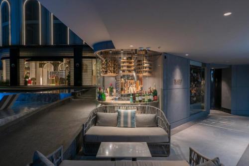 a pool bar with a couch in the middle of a restaurant at The Salil Hotel Riverside Bangkok in Bangkok
