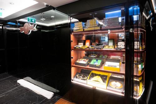 a display case in a store filled with lots of items at The Salil Hotel Riverside Bangkok in Bangkok