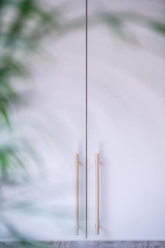 two wooden sticks standing in front of a door at Apartament Mikołowska z balkonem in Gliwice