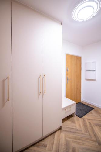 a large white closet in a room with wood floors at Apartament Mikołowska z balkonem in Gliwice