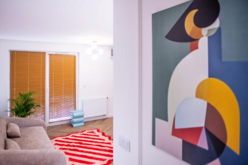 a living room with a chair and a rug at Apartament Mikołowska z balkonem in Gliwice