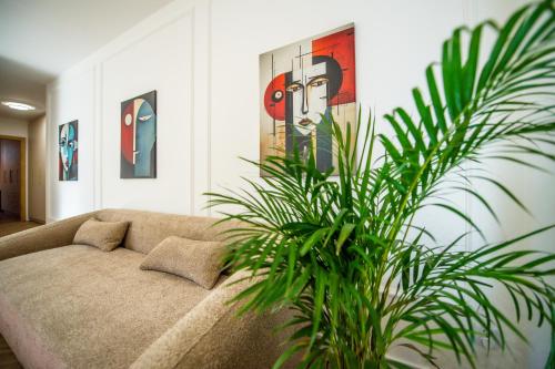 a living room with a couch and a plant at Apartament Mikołowska z balkonem in Gliwice