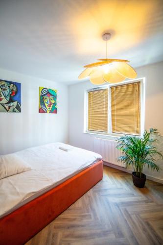 a bedroom with a large bed and a window at Apartament Mikołowska z balkonem in Gliwice