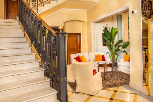 a staircase in a home with chairs and a table at Grand Hotel Bastiani in Grosseto