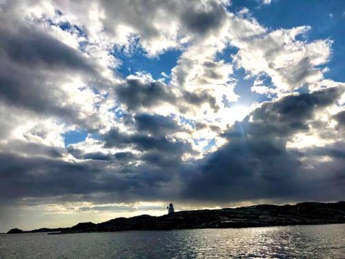 a cloudy sky over a body of water at Brightside Apartment in Kristiansand