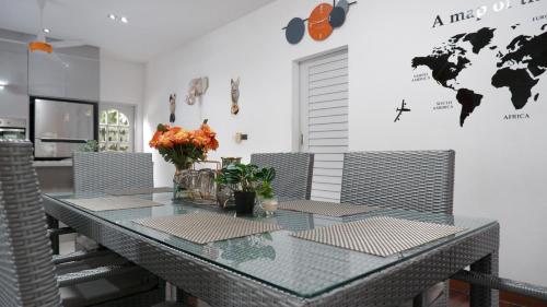 a dining room with a glass table and chairs at Bangrak Cozy Stay in Koh Samui 