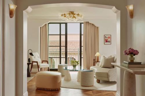 a living room with a couch and a table at The Maybourne Beverly Hills, Maybourne in Los Angeles