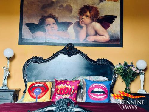 a bedroom with a bed with a picture above it at Greystonedale Mansion, Haltwhistle in Haltwhistle