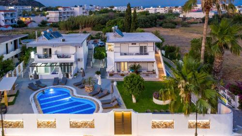 an aerial view of a house with a swimming pool at Toula's Apartments in Faliraki
