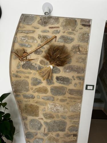 a stone wall with a clock on it at La Spiga in Gangi