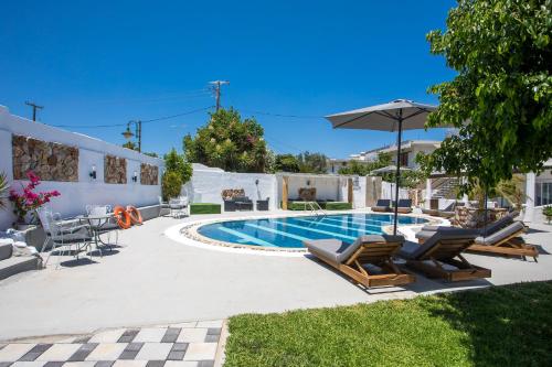 a swimming pool with lounge chairs and an umbrella at Toula's Apartments in Faliraki