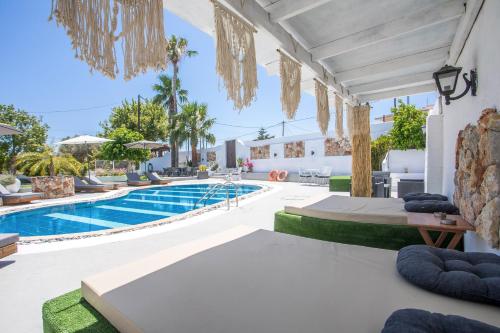 a villa with a swimming pool and a resort at Toula's Apartments in Faliraki