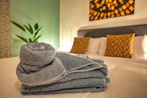 a pile of towels sitting on top of a bed at Duplex tastefully furnished flat in Valletta MCOP1-1 in Valletta