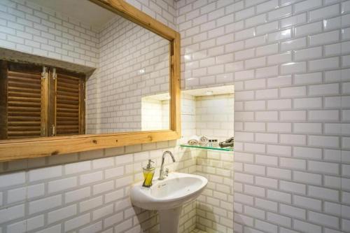 a white bathroom with a sink and a mirror at Moustache Jaisalmer in Jaisalmer