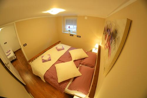Una vista de un pequeño dormitorio con una cama. en Apartment Arpa, en Liubliana
