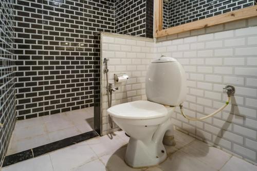 a bathroom with a white toilet in a brick wall at Moustache Jaisalmer in Jaisalmer