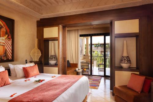 a bedroom with a large bed and a balcony at Les Jardins De La Koutoubia in Marrakech