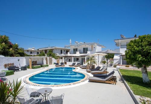 a swimming pool in the backyard of a house at Toula's Apartments in Faliraki