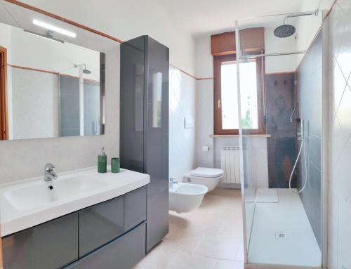a bathroom with a sink and a toilet and a shower at La Casa di Edo in Verona