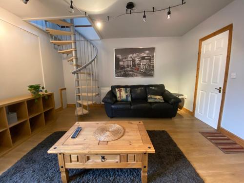 a living room with a couch and a coffee table at Host & Stay - Studley Knapp in Milton Keynes
