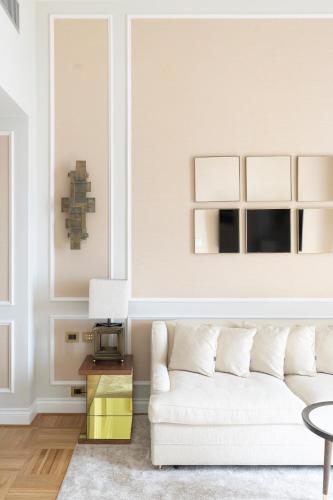 a living room with a white couch and a table at Grand Hotel Principe Di Piemonte in Viareggio