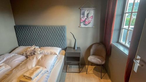 a bedroom with a bed and a table with a lamp at Trysil-Knut Hotel in Trysil
