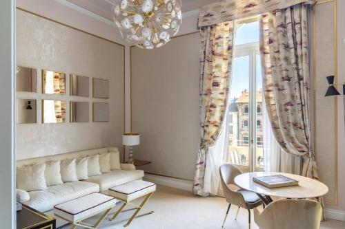 a living room with a couch and a table at Grand Hotel Principe Di Piemonte in Viareggio