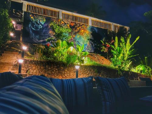 a wall with an aquarium with lights on it at Blue Whale Villa - Penthouse in Calibishie