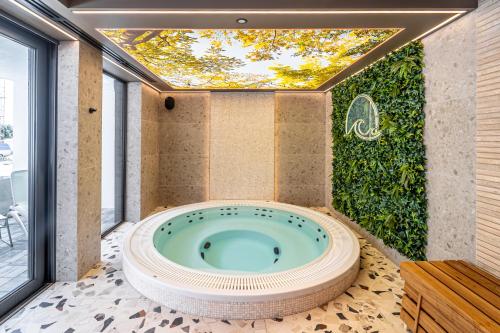 a jacuzzi tub in the middle of a room at POSESJA APARTAMENTY & SPA - Posesja Plażowa 4a I in Grzybowo