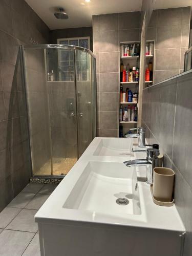 a bathroom with two sinks and a shower at Delight room 1st door in Nice