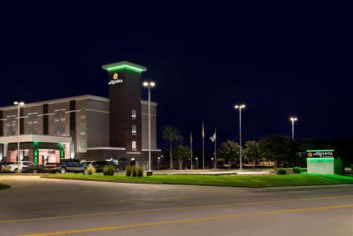 a large building with a clock tower at night at La Quinta by Wyndham Gonzales LA in Gonzales