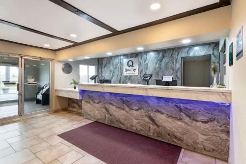 a lobby with a counter with a large aquarium at Quality Inn Newton at I-80 in Newton