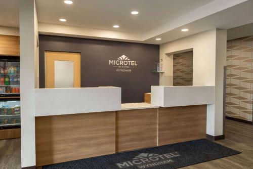a pharmacy with a sign on the wall at Microtel Inn & Suites by Wyndham Val-d Or in Val-dʼOr